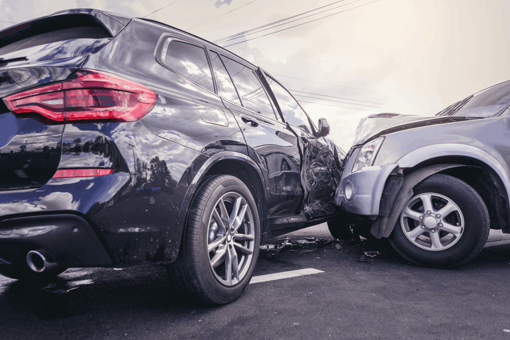The aftermath of a silver SUV t-boning a black SUV.