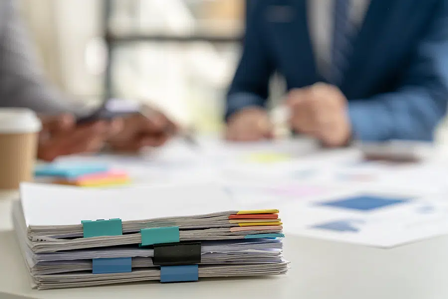 A stack of legal documents with colorful tabs.