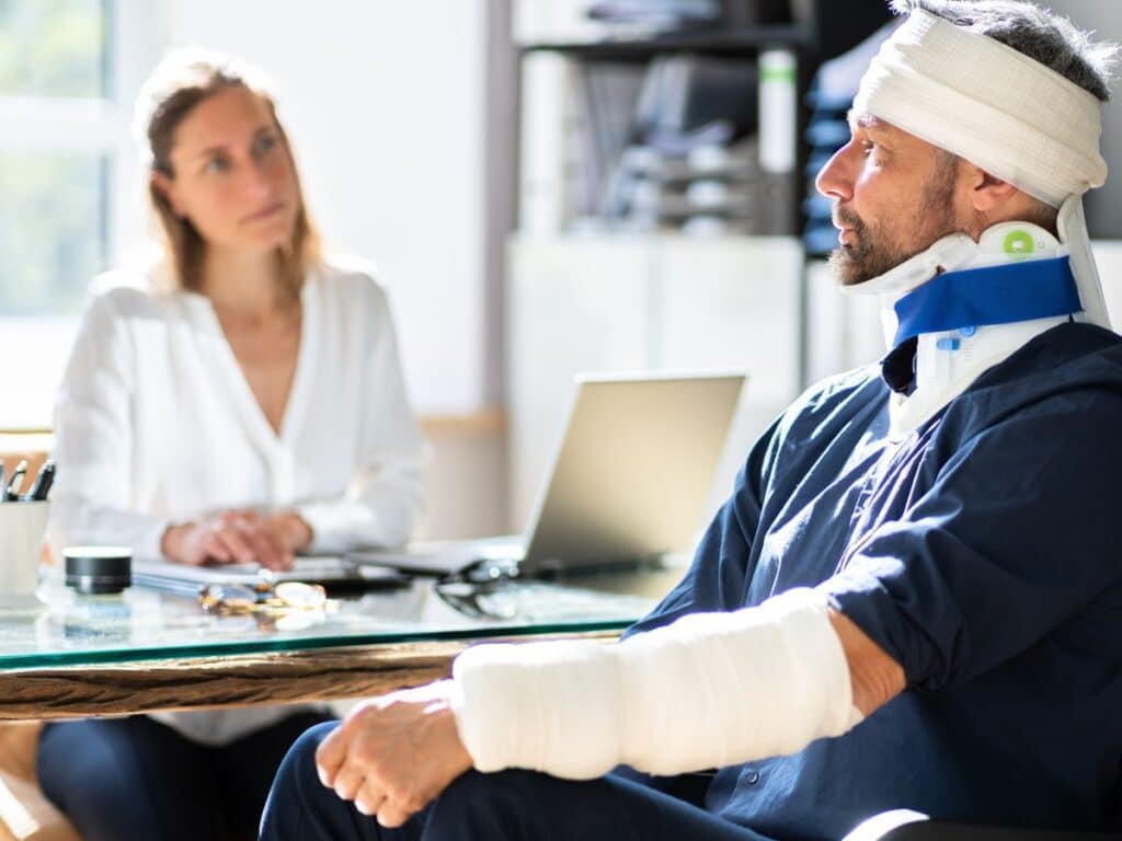 A female personal injury attorney meeting with an injured client.