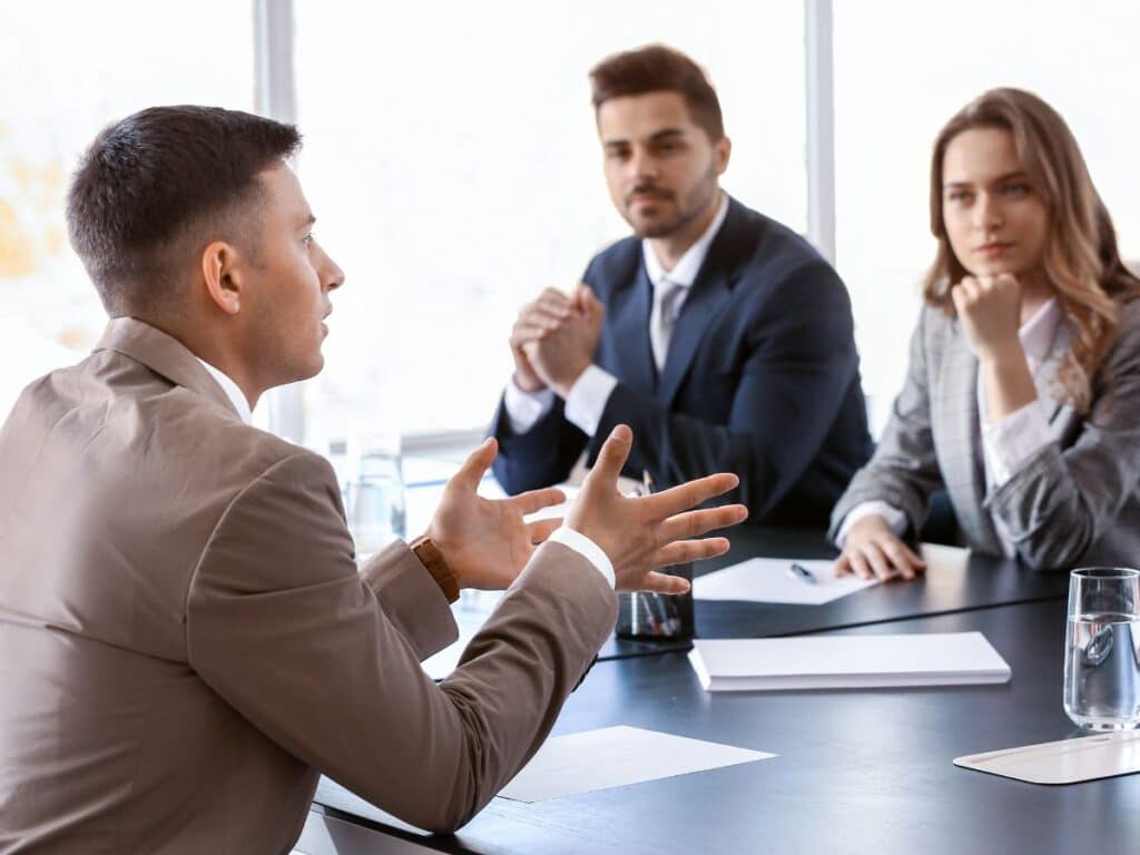 A group of personal injury attorneys listening to a plaintiff during a legal deposition.